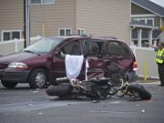 A Clark County Sheriff's deputy directs traffic as police investigate a fatal accident involving a minivan and motorcycle Tuesday morning.