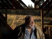 Chuck Cushman, executive director of the American Land Rights Association, stands inside an old barn on his Battle Ground property.He's fighting against Rialto Capital Management in hopes of spurring changes in how the government handles bank closures.