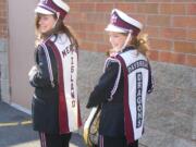 Daybreak Middle School seventh-graders Jessie Wiseman, left, and Briana Robbins, display the uniform overlays, one with the Mercer Island identifier and one with new Daybreak Dragons patches.