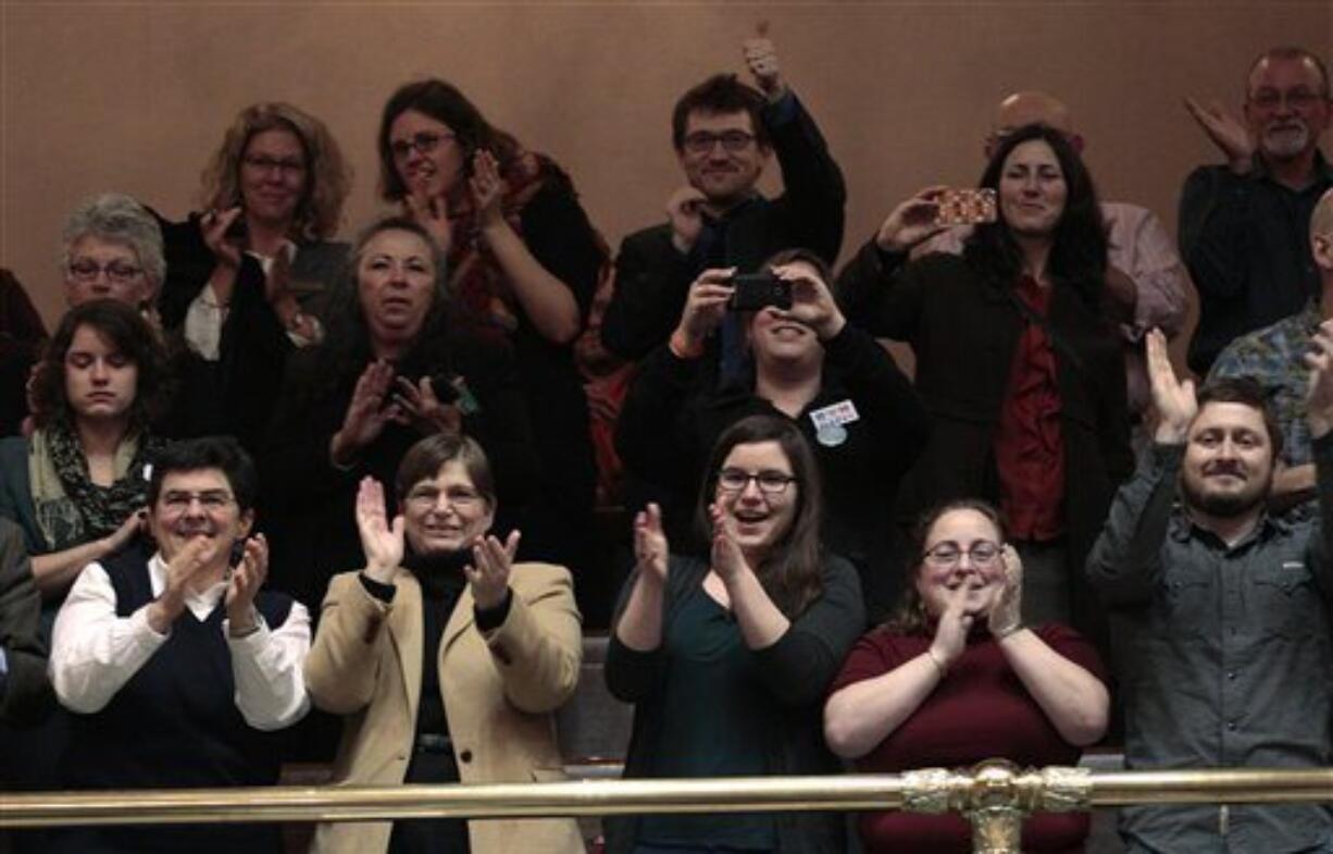 Spectators in the House gallery applaud after after legislators voted to legalize gay marriage in Washington state Wednesday, Feb. 8, 2012, in Olympia, Wash. The action comes a day after a federal appeals court declared California's ban on same-sex marriage unconstitutional, saying it was a violation of the civil rights of gay and lesbian couples. Gregoire is likely to sign the bill next week.