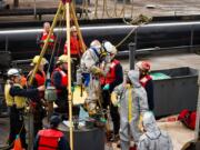 Portland firefighters recovered the body of a man from a barge tank Sunday.