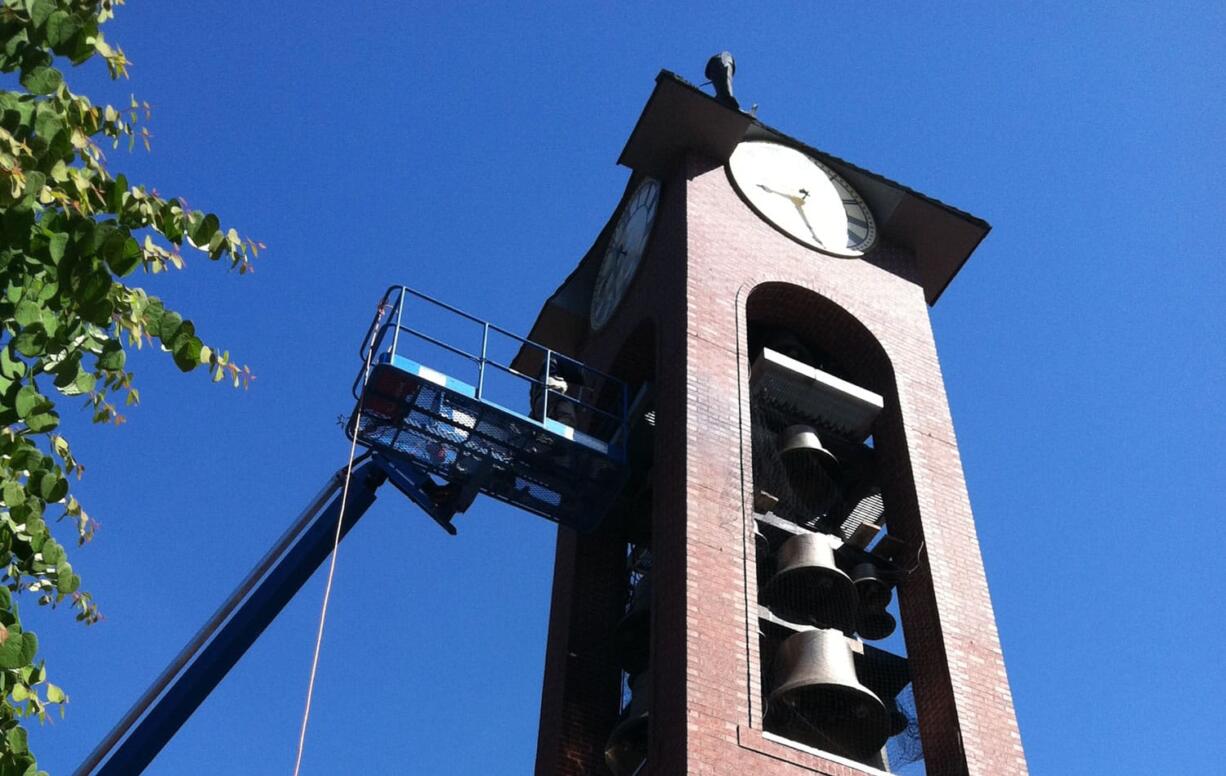 Crews working on the bell tower at Ester Short Park on Monday.