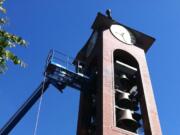 Crews working on the bell tower at Ester Short Park on Monday.