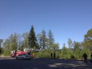 Police use a ladder truck to get a birds-eye view of a scene along Highway 503 in Battle Ground where a body was reportedly found.