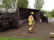 A dump truck driver was sent to the hospital with minor injuries after his rig went off the road on state Highway 502 and flipped on its side.