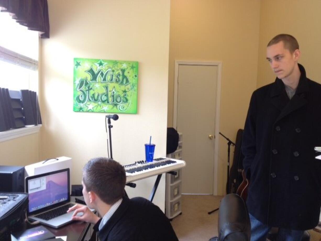 Denton Holmgren, 17, right, who is battling cancer, and his brother Lucas, 21, left, spend time in a recording studio at their family home in Battle Ground, which was furnished by the Make a Wish Foundation on Tuesday.