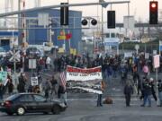 Protesters set up a picket line at a Port of Portland terminal Monday in Portland as part of a West Coast &quot;day of action.&quot; Anti-Wall Street protesters along the West Coast joined an effort Monday to blockade some of the nation's busiest docks, with the idea that if they cut off the ports, they cut into corporate profits.