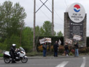 A group of demonstrators held signs outside the main entrance to the Port of Vancouver on Thursday morning.