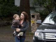 Sarah Remington drops off her son Jacob, 2, at Wendy's Teddy Bear Day Care in Vancouver in a Columbian file photo from October. Remington, a single mom, received a $3,000 bill in the mail from the state saying it paid her for child care subsidies for which she was ineligible. The state approved Remington in error, and now, she's responsible for the bill, which she can't afford.