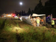 TLC Towing crews respond to an overturned semi truck on the state Highway 14 ramp to south Interstate 205 early Tuesday.