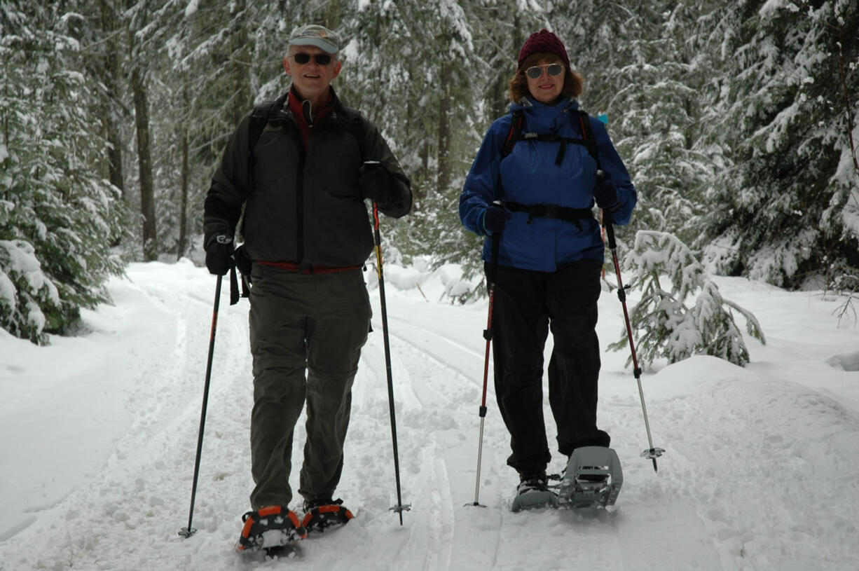 A pair of snowshoers return to Atkisson Sno-Park west of Trout Lake in the Gifford Pinchot National Forest.