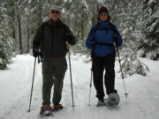 A pair of snowshoers return to Atkisson Sno-Park west of Trout Lake in the Gifford Pinchot National Forest.