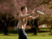 Geoff Kunkle, 22, plays frisbee with a friend between classes at Clark College this week.