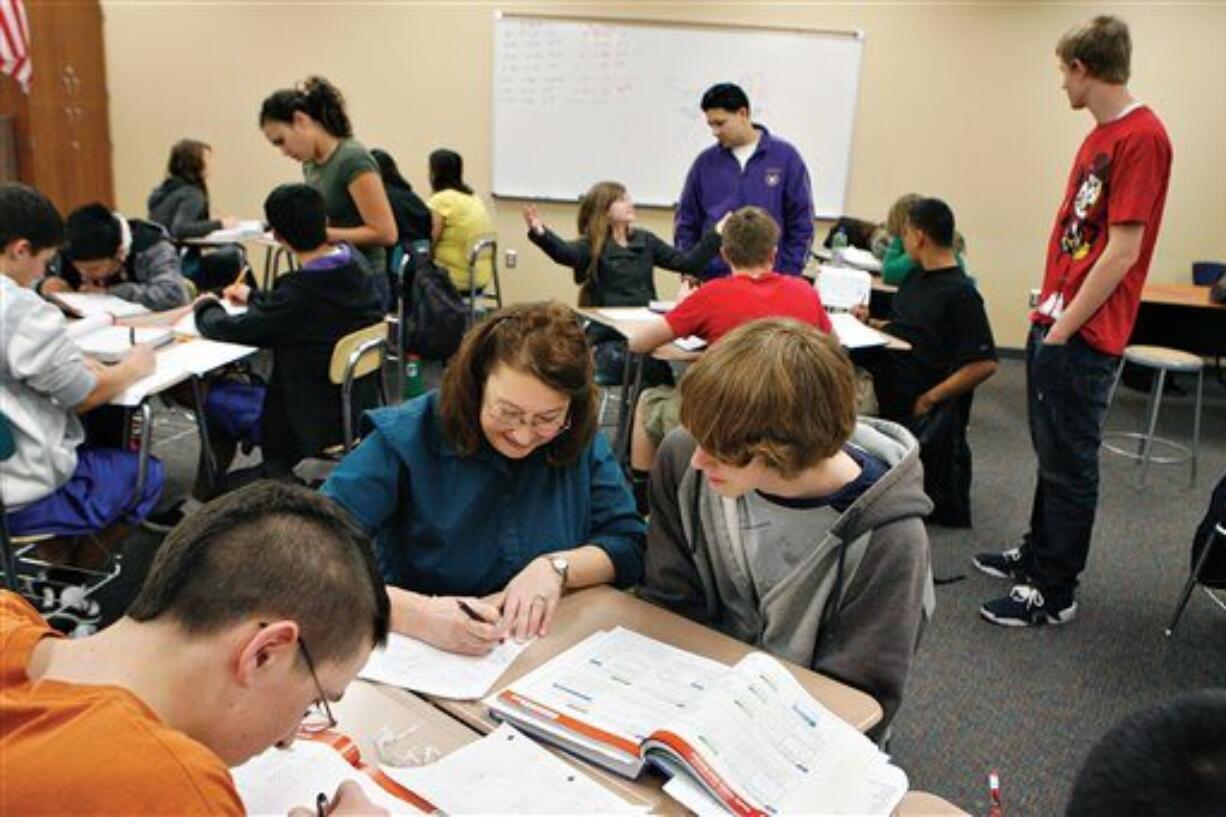 In an undated photo Kiona-Benton math teacher Susan McTavish, front, works with Stephan Tenisch, 15, during a pre-algebra class as GEAR UP tutors Teresa Wight, back left, Jaime Garcia, in purple, and Montana McAllister, right, help other students one on one. Kiona-Benton won Washington Achievement Awards in overall excellence and language arts.