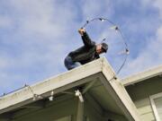 Art Rairdon takes advantage of what was forecast to be the last dry day this week to put up his Christmas lights. &quot;I should have put them up yesterday,&quot; said Rairdon.