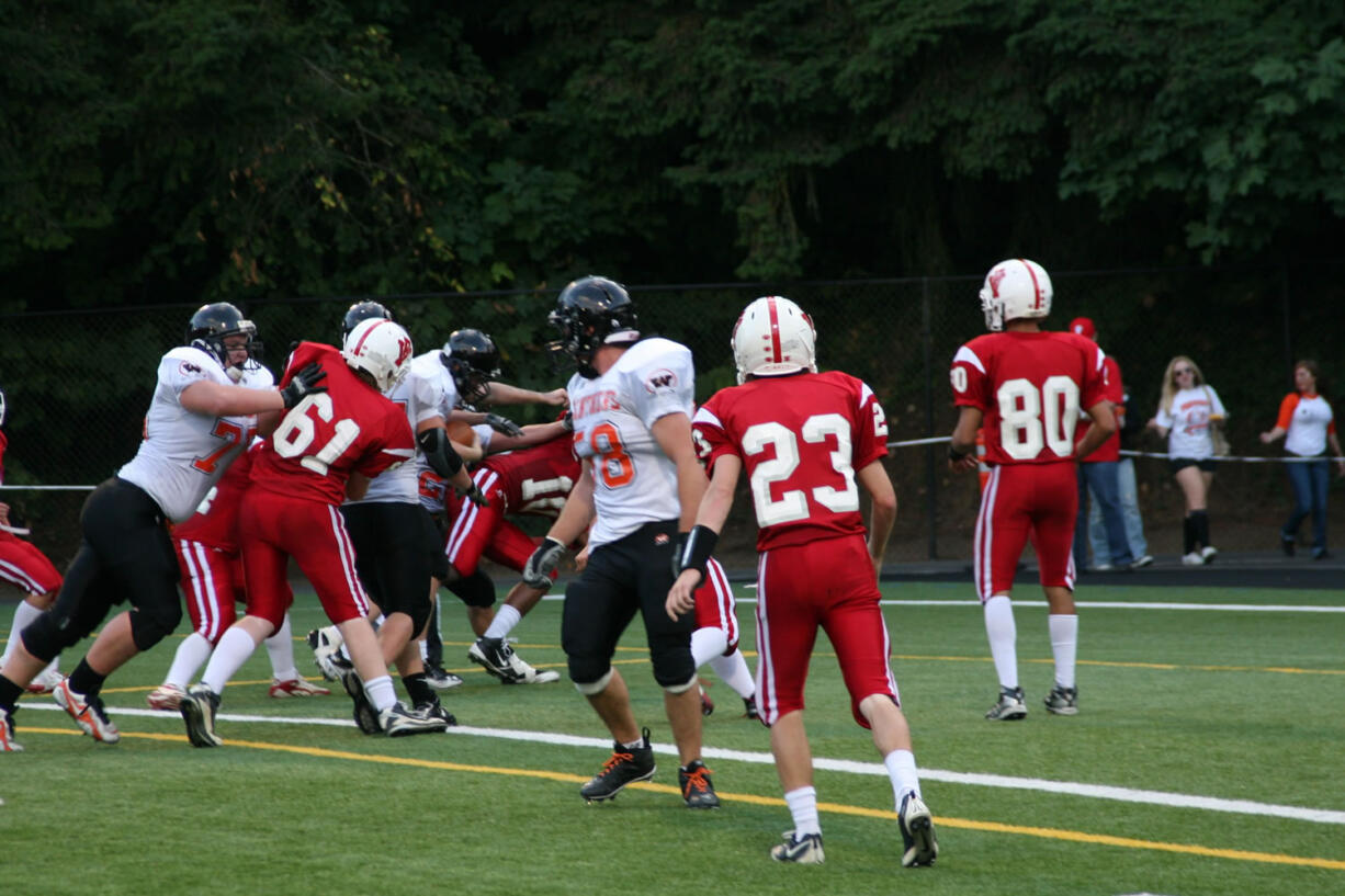 Caleb Howard glides into the end zone with the help of his Washougal teammates Friday, at Kiggins Bowl. The senior scored a touchdown, recovered a fumble and snagged an interception to help the Panthers win 41-28.