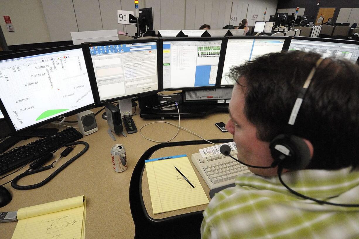 John Gaylord, graveyard supervisor at the CRESA 911 dispatch center, takes calls.