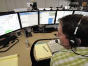 John Gaylord, graveyard supervisor at the CRESA 911 dispatch center, takes calls.