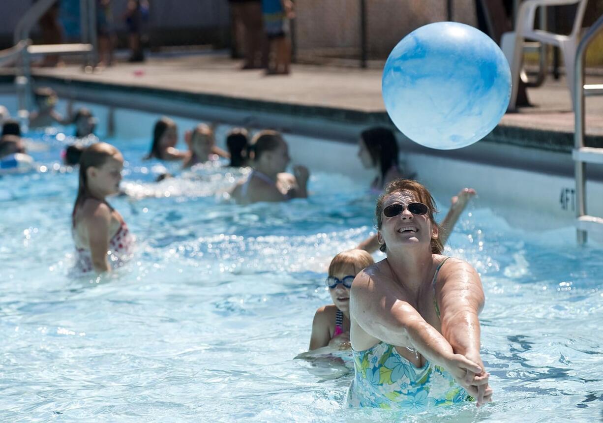 Silvana Tesar, from Battle Ground, plays with her kids at the Camas swimming pool on Wednesday afternoon.