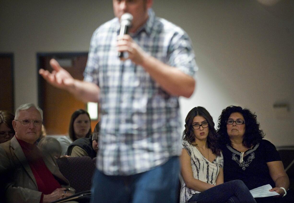 Vicki Dobbin, right, sits with her daughter, Molli Dobbin, 18, while listening to Aaron Chidester, executive director of Unite 4 Life, during a suicide-prevention seminar Thursday at City Harvest Church.