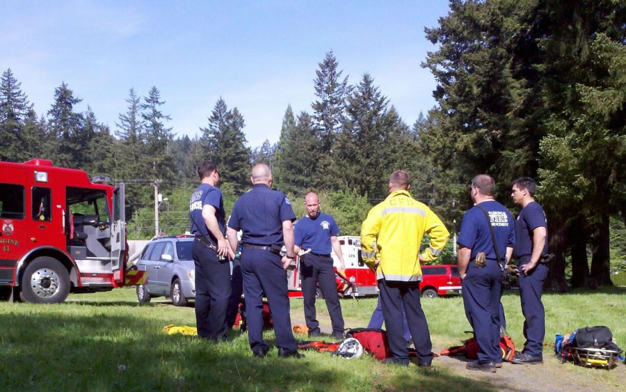 Crews debrief after drills at the &quot;Pot Holes&quot; area of Lacamas Creek.