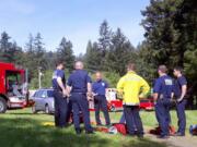 Crews debrief after drills at the &quot;Pot Holes&quot; area of Lacamas Creek.