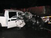 A pick-up truck was heavily damaged but its driver not believed to be seriously injured when it crashed into a parked flatbed truck loaded with concrete barriers.