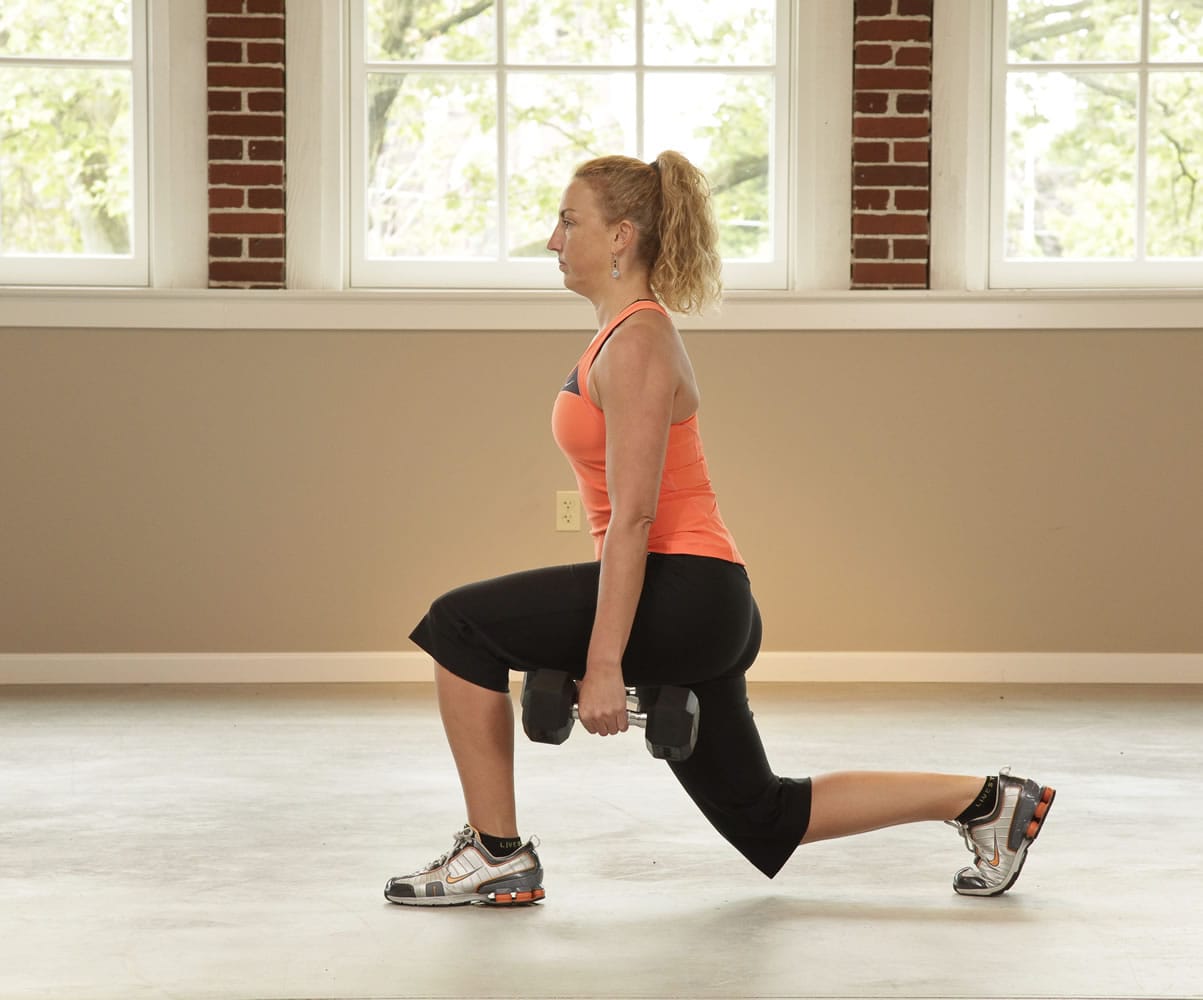 Slowly lower the back knee towards the ground keeping the front knee over top the ankle the entire time. Keep your body weight positioned over the front leg - this is your working leg.  Maintain proper posture and keep your abdominals contracted.  Only go as low as you feel comfortable. To increase intensity, you can hold hand weights.