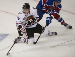 The Portland Winterhawks' Ty Rattie takes a shot from his knees while being defended by the Edmonton Oil Kings's Keegan Lowe in the third period of game 3 in the WHL Finals at the Rose Garden on Sunday May 6, 2012.