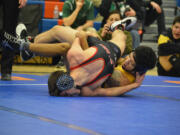 Darion Green of Hudson's Bay, right, wrestles with Orion Yates of R.A. Long during the Class 2A Greater St. Helens League Sub-Regional Tournament on Saturday at Ridgefield High School. (Micah Rice/The Columbian).