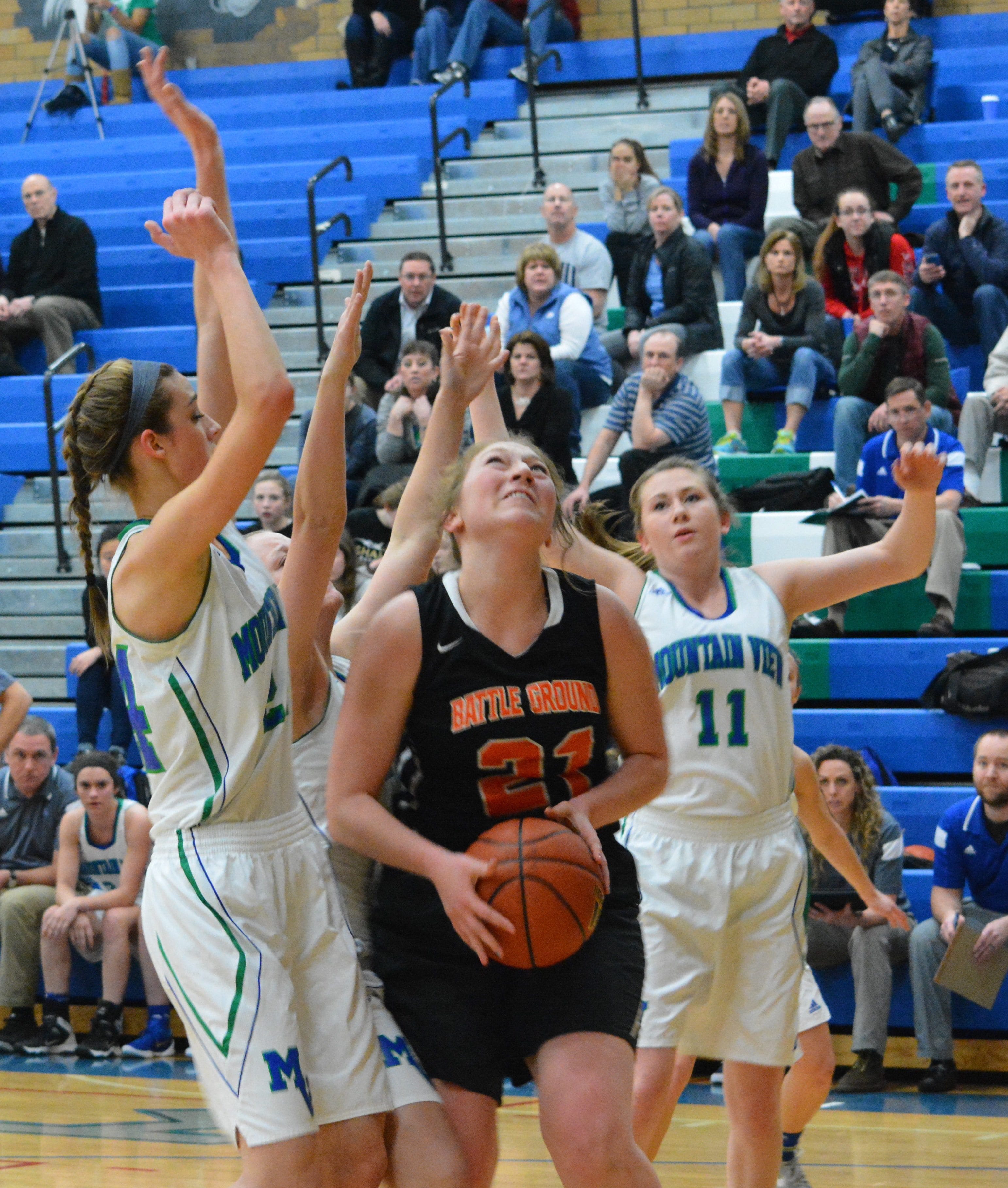 Battle Ground&#039;s Kylie Smith goes up for a shot while Mountain View&#039;s Hailey Hartney, left, and Emilly Moore defend during the first half of a 4A District 4 Tournament game Tuesday at Mountain View.