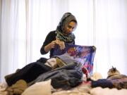 Saarah Bhaiji, 16, folds one of her many headscarves at her home Jan. 31 in Glenview, Ill. Bhaiji teaches at the Muslim Education Center in Morton Grove on Sundays and attends Glenbrook South High School as a junior during the week, where she said her experience as a Muslim has been mostly positive.