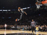 Minnesota Timberwolves&#039; Zach LaVine slam dunks the ball during the NBA all-star skills competition in Toronto on Saturday, Feb. 13, 2016.