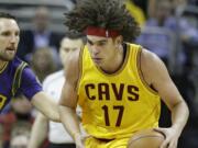 Cleveland Cavaliers' Anderson Varejao (17), from Brazil, drives past New Orleans Pelicans' Ryan Anderson (33) in the first half of an NBA basketball game Saturday, Feb. 6, 2016, in Cleveland.