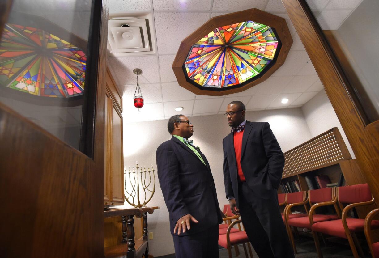 The Rev. Cleveland Mason, a pastor at Perkins Square Baptist Church, left, and the Rev. Domanic Smith, pastoral outreach coordinator at Sinai Hospital, talk in the Sinai chapel in Baltimore.