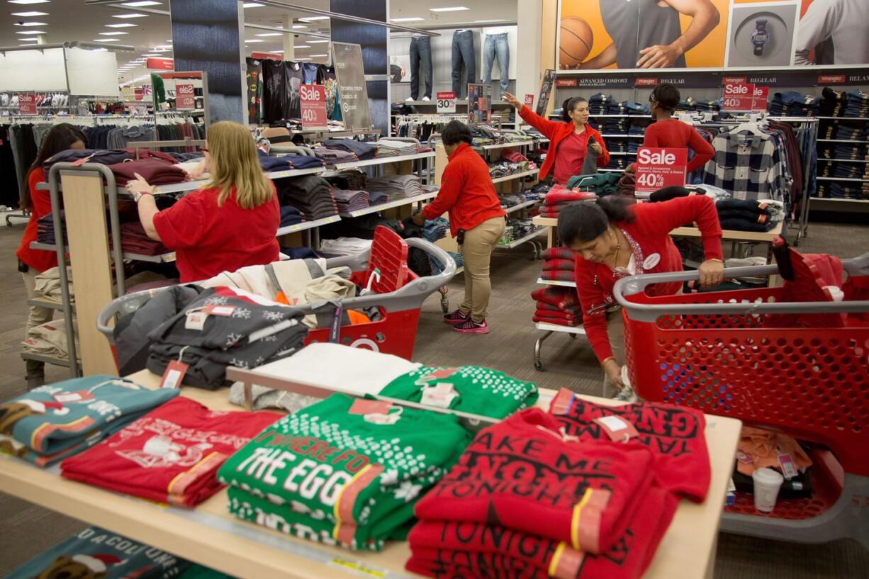 Target Corp. employees refold clothes displayed for sale at a Target Corp. store in Jersey City, N.J., on Black Friday.