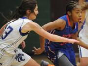 La Center player Andrea Griffee (L) and Shelby Vermeulen (R)  pursue  Benson's Janae Brown (C) at a girls basketball game at Evergreen High School in Vancouver Monday December 28, 2015.