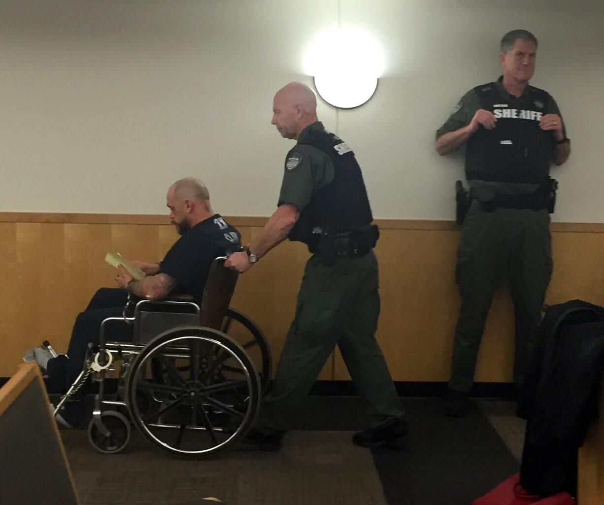 Douglas Atkins used a wheelchair for his first court appearance in December after a car chase that ended with a crash. He was sentenced Friday to more than two years in prison.