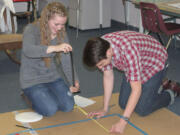 CHS Science Olympiad team members, including sophomore Katelynne Jones (left) and senior Ryan Gompertz (right) gathered Monday night to practice for the upcoming national tournament on May 20 and 21 in Wisconsin. Five days a week the team works out of its &quot;clubhouse,&quot; one of the portables at Lacamas Heights Elementary School.