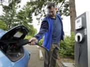 Patrick Conner plugs in his Nissan Leaf at a charging station at the public library in Hillsboro, Ore., in May 2015. West of the Cascades, it&#039;s not hard to find a place to give a battery a fill-up, but Avista says more stations in Eastern Washington, 45 of them in public sites, could be a big help in the state&#039;s goal to go from 12,000 electric vehicles to 50,000 by 2020.