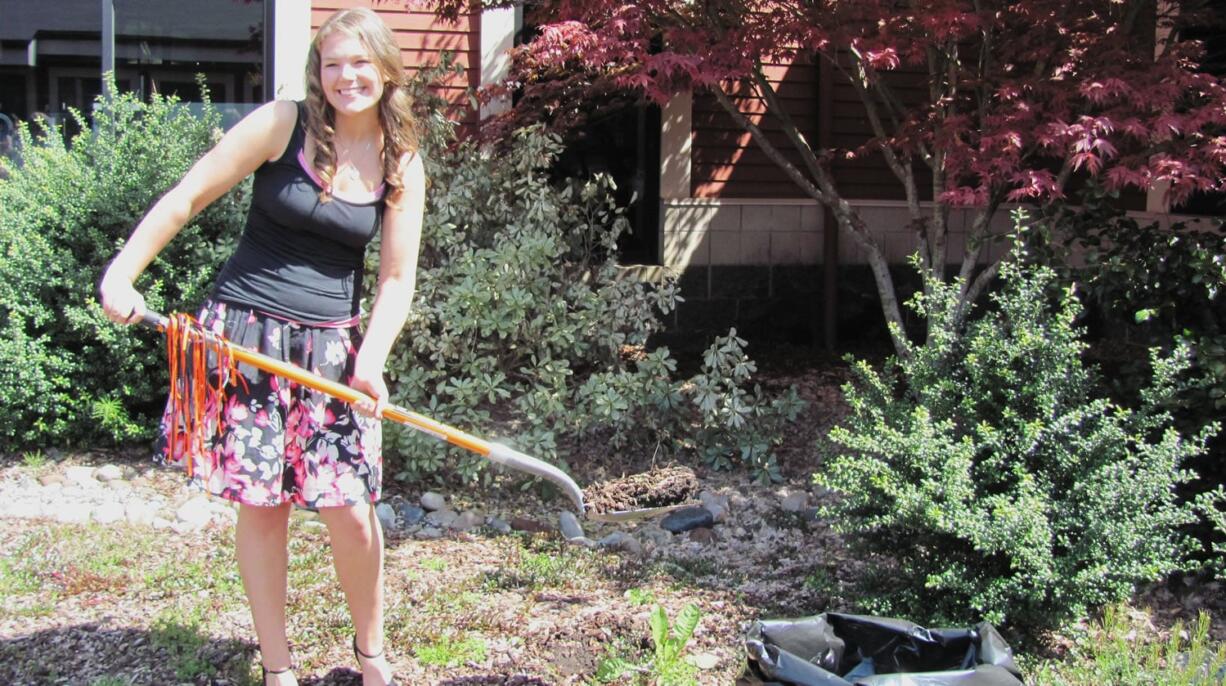 WHS senior Emily Carroll prepares to bury her time capsule in the school courtyard.