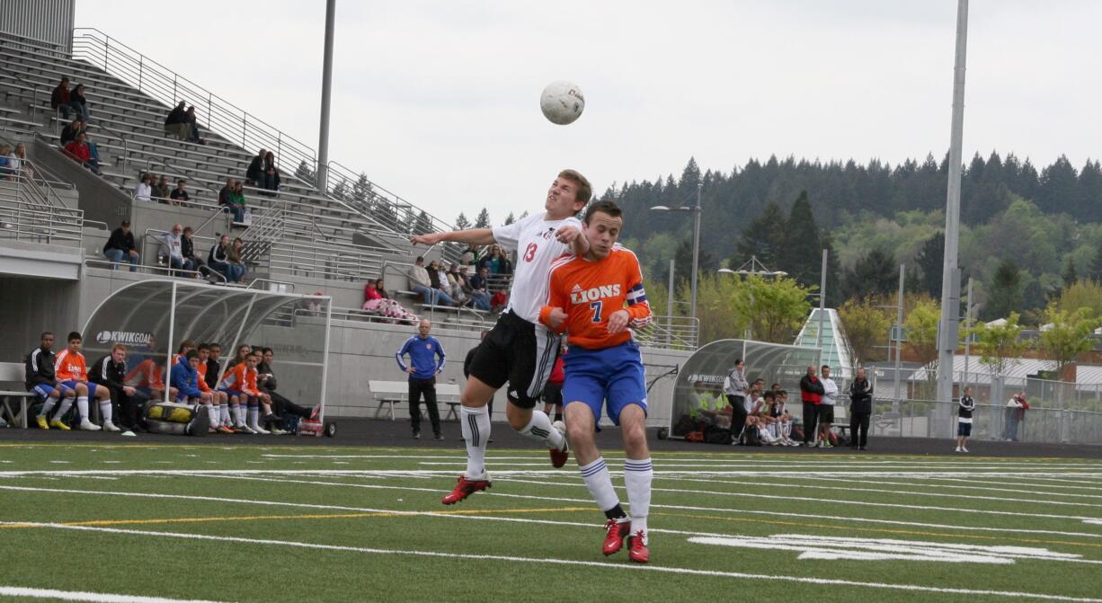 Parker Roland (left) heads up for the soccer ball Saturday, at Doc Harris Stadium.