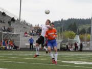 Parker Roland (left) heads up for the soccer ball Saturday, at Doc Harris Stadium.