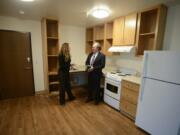 Amy Reynolds of Share, left, and Steve Towell of the Vancouver Housing Authority talk in the kitchen of a larger unit at Lincoln Place that was built for people with disabilities.