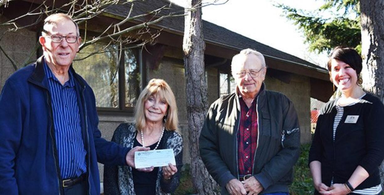 American Legion's Phil Yasson hands Judy Starr, of the foundation, a $10,000 gift, while Gary Zilm from American Legion and the foundation&#039;s Kelsey Hukill look on.