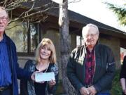 American Legion's Phil Yasson hands Judy Starr, of the foundation, a $10,000 gift, while Gary Zilm from American Legion and the foundation&#039;s Kelsey Hukill look on.