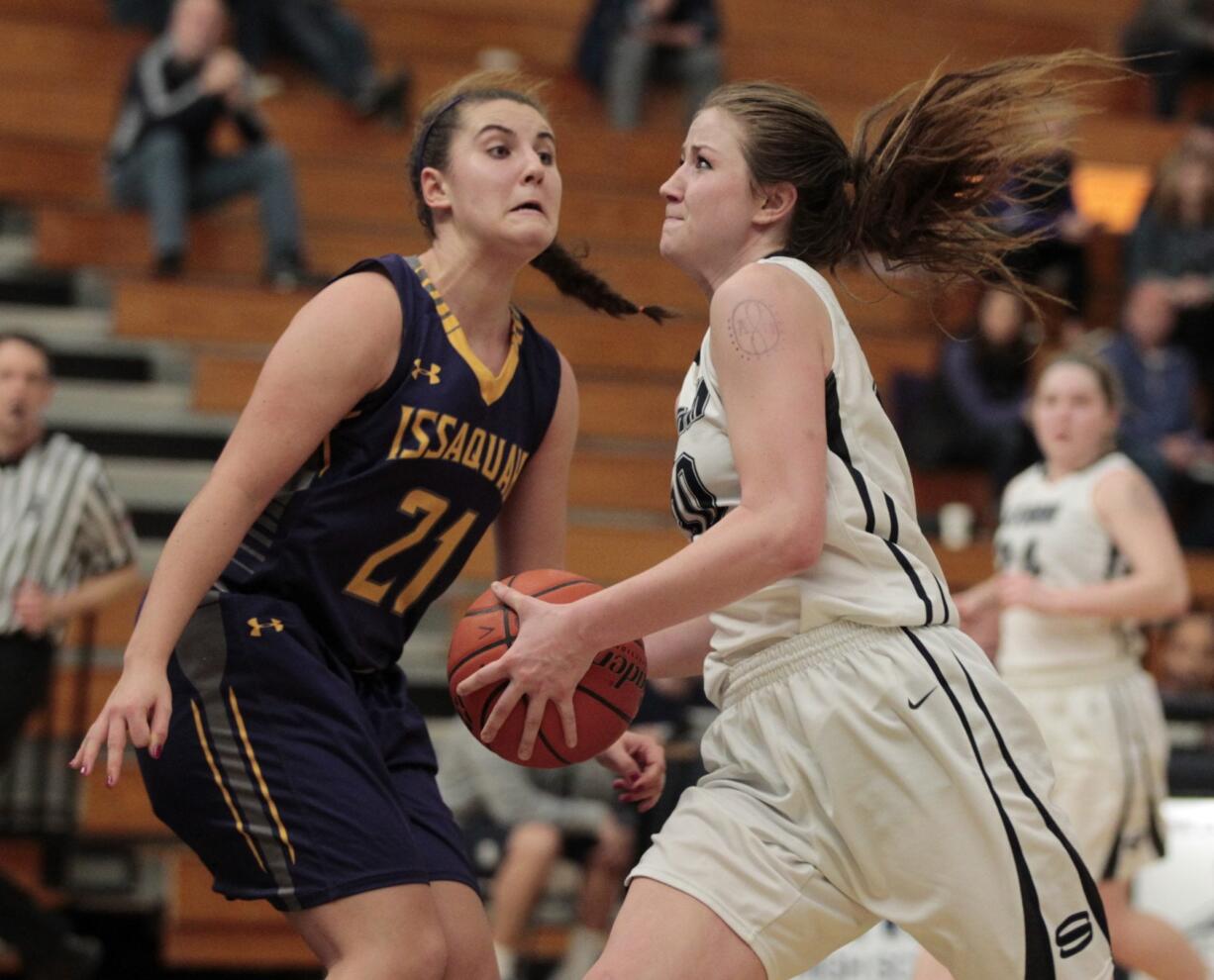 Skyview&#039;s Ashlee Comastro, right, drives to the hoop past Issaquah&#039;s Mariah Van Helm (21). Comastro scored 16 points in the Storm&#039;s win.