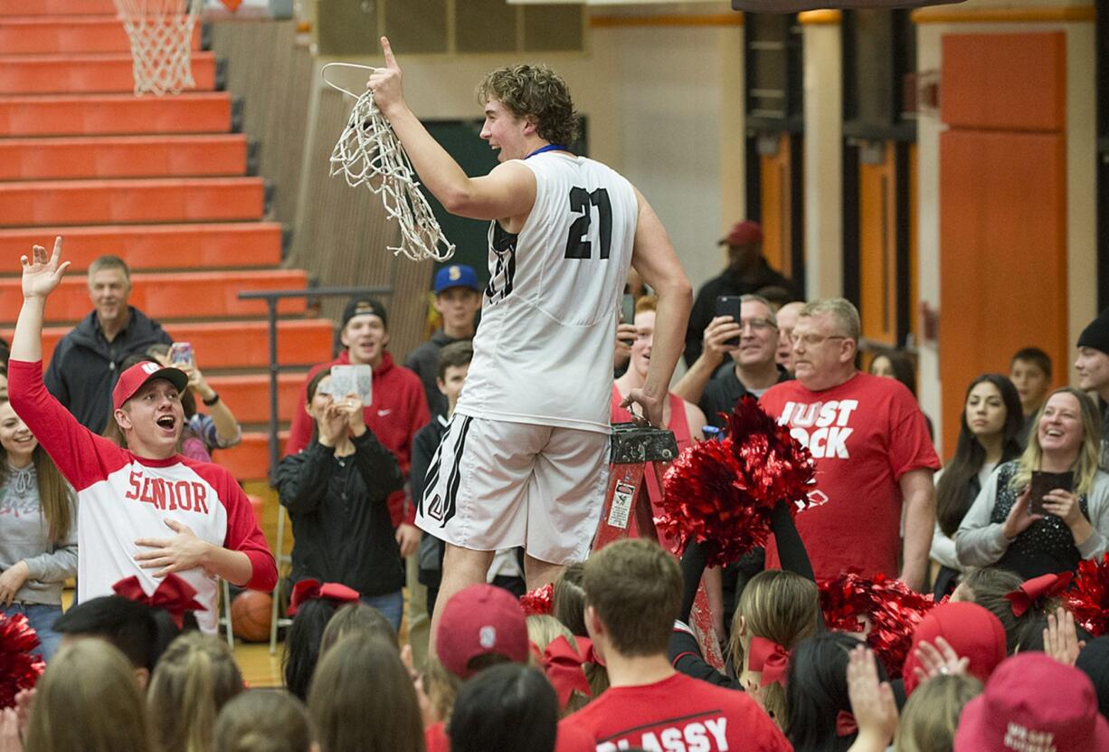 Union&#039;s Nico Bricker (21) celebrates the win with teammates and fans Tuesday evening, Feb. 16, 2016 at Battle Ground High School.