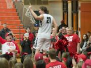 Union&#039;s Nico Bricker (21) celebrates the win with teammates and fans Tuesday evening, Feb. 16, 2016 at Battle Ground High School.