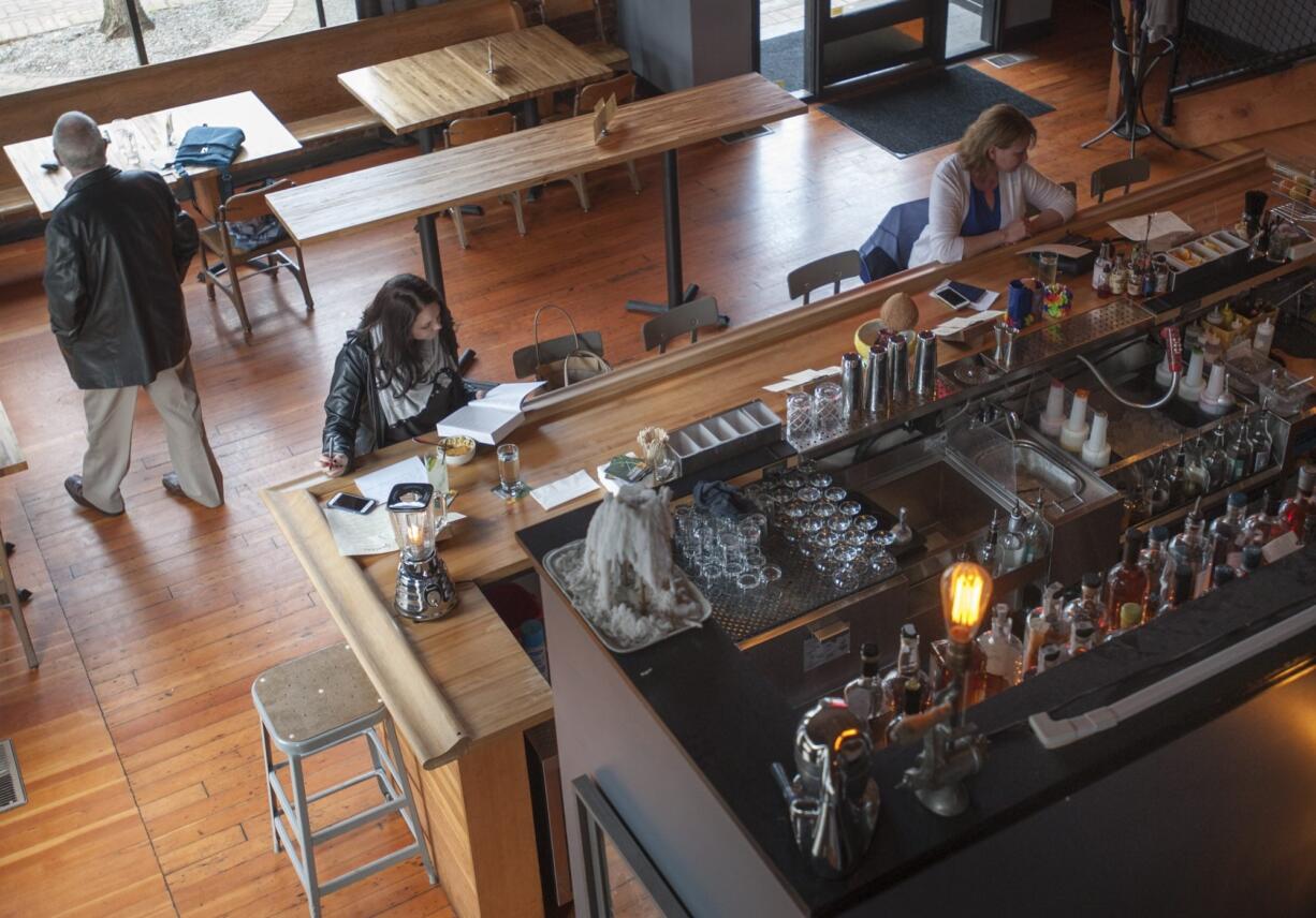 Customers enjoy happy hour at The Grocery Cocktail &amp; Social in Vancouver. Many say the food scene is improving in Clark County even as it competes with Portland&#039;s culinary dominance.